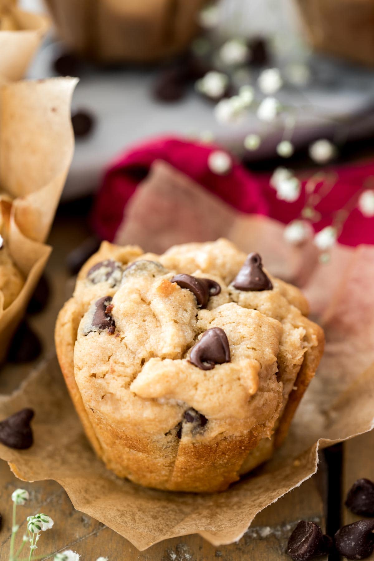 peanut butter muffin with chocolate chips on brown parchment paper