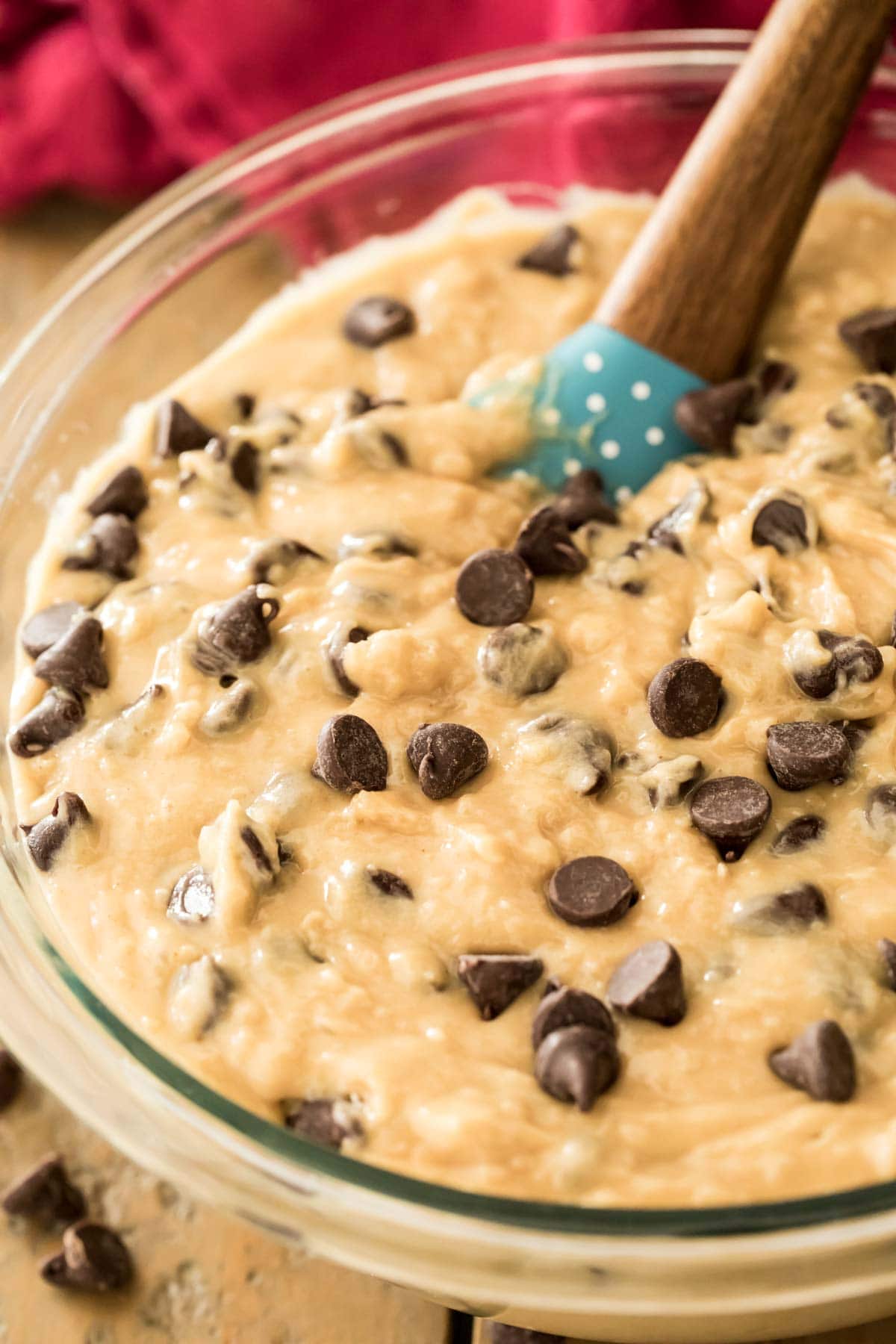 muffin batter in glass bowl with blue spatula