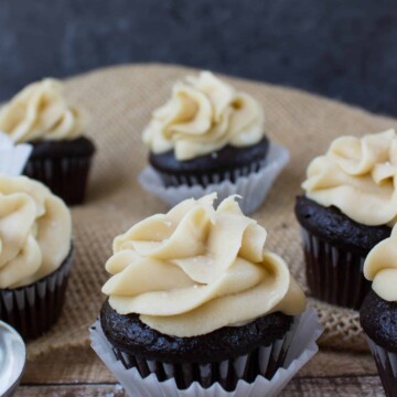 mini dark chocolate cupcakes with caramel frosting in cupcake wrapper