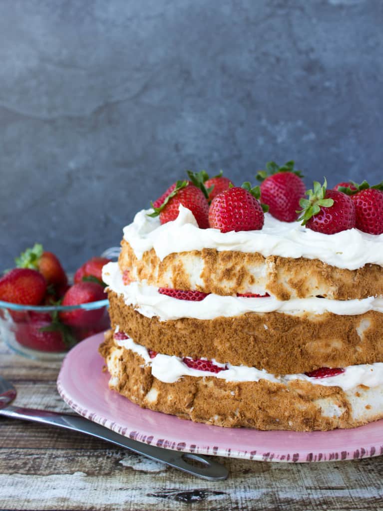 Lemon Layered Angel Food Cake on pink platter