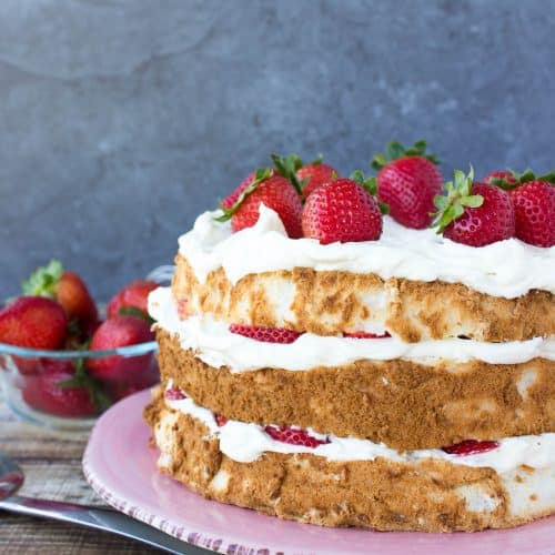 layered cake with strawberries on top and filling