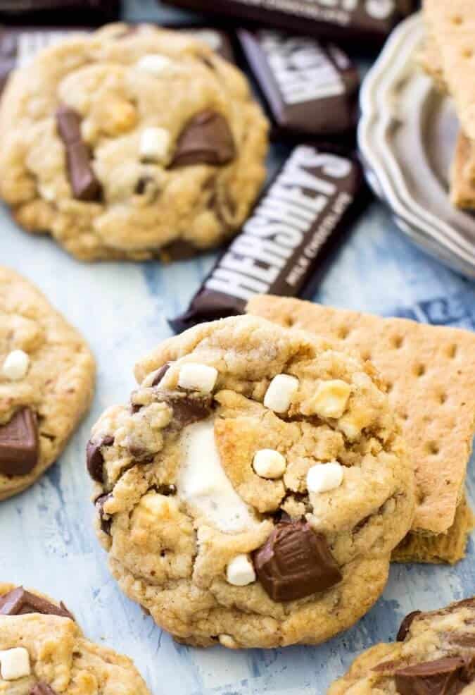 S\'mores cookies with graham crackers and marshmallows and mini Hershey\'s bars in the background