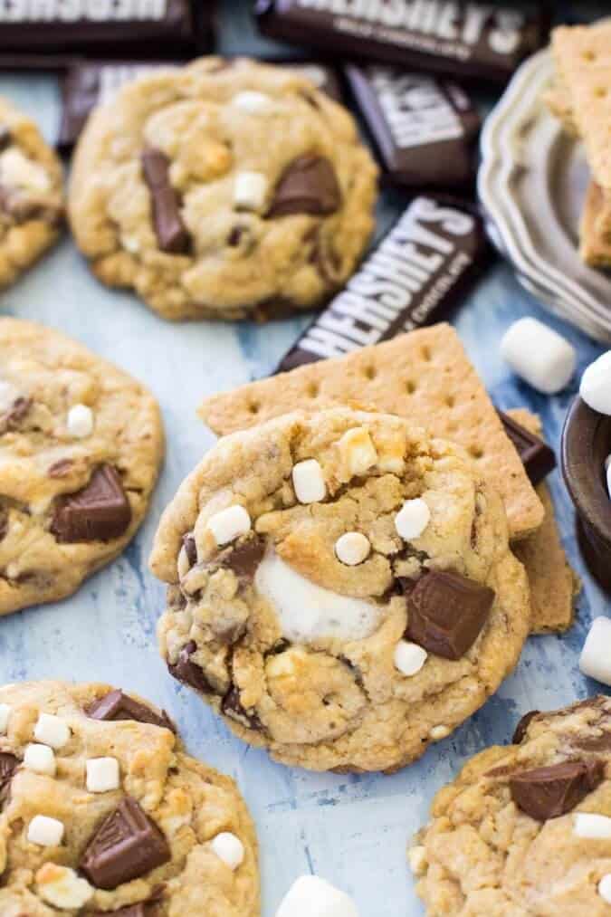S\'mores cookies with graham crackers and marshmallows and mini Hershey\'s bars in the background