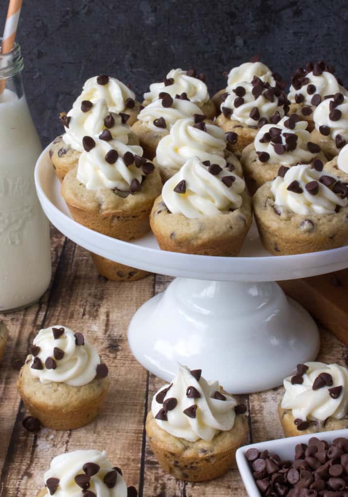 cookie cups with cheesecake and chocolate chips on white cake stand