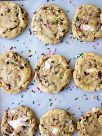overhead view of funfetti filled chocolate chip cookies on baking sheet