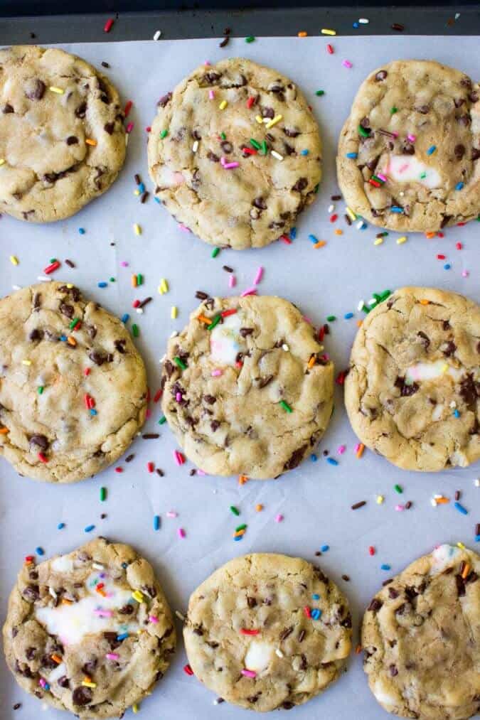 overhead view of funfetti filled chocolate chip cookies on baking sheet