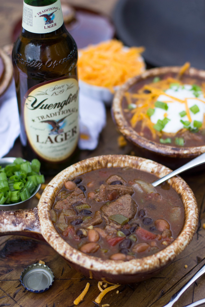 Beer Steak Chili in crock with spoon, Yuengling beer in background