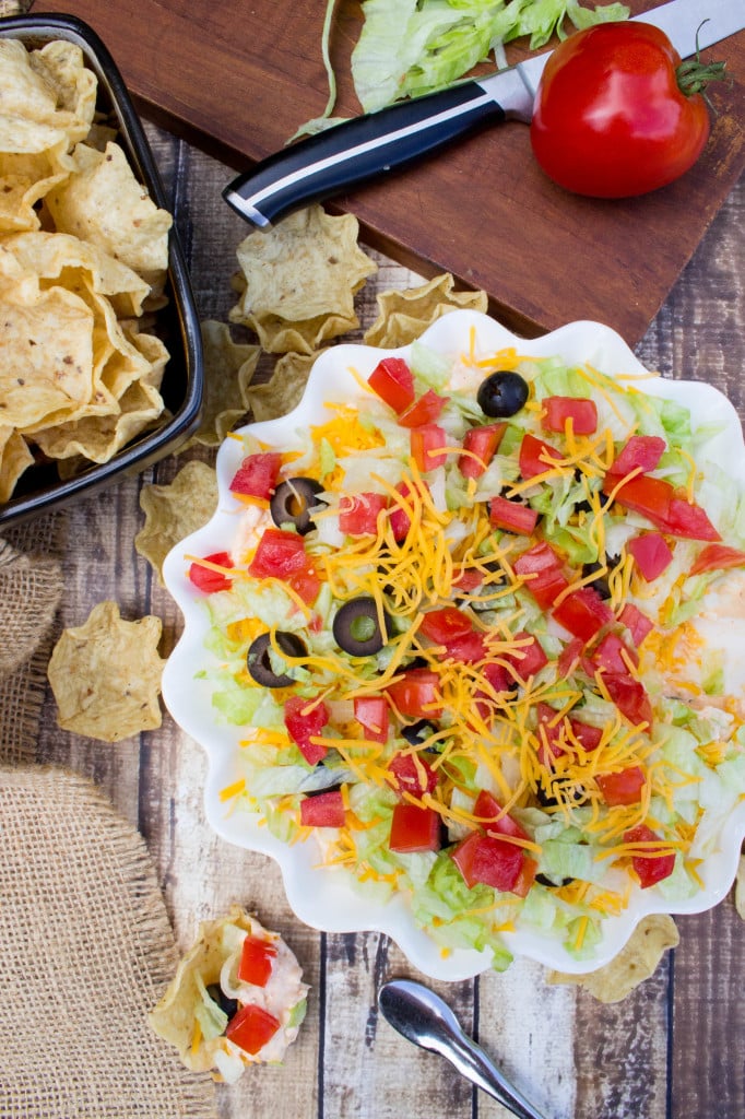 overhead of taco dip in white serving dish