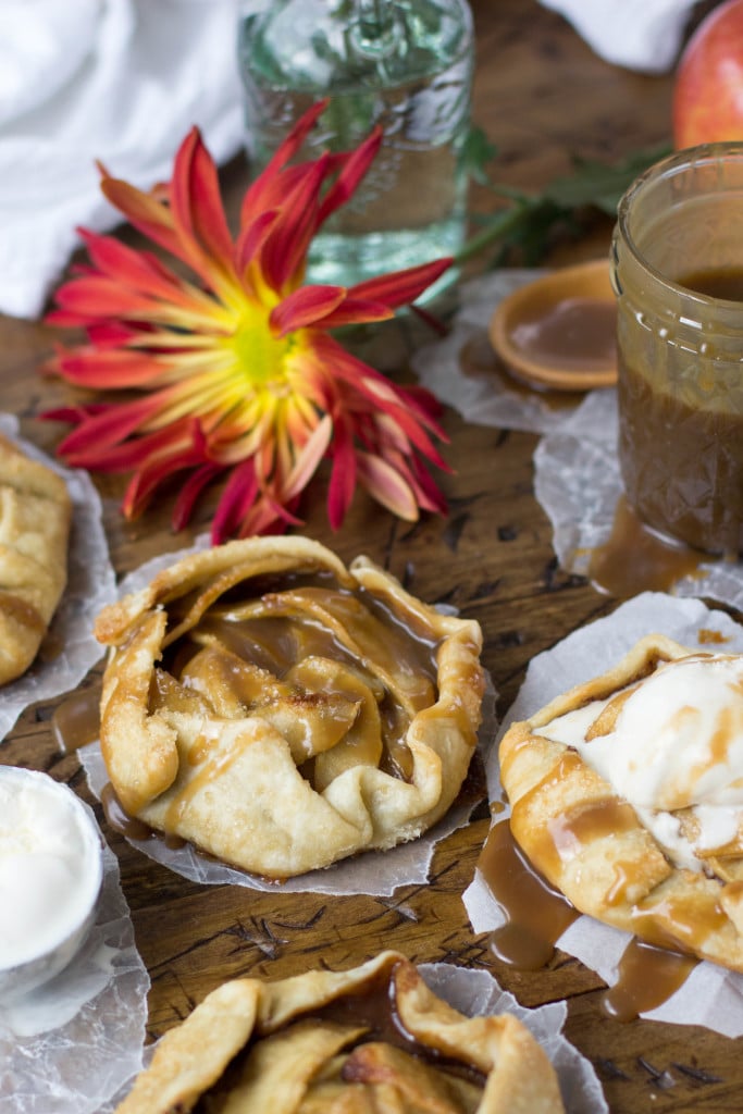 apple galette with caramel sauce; red flower in background