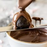 Melted chocolate poured over oreo truffle