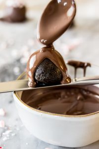 Melted chocolate poured over oreo truffle