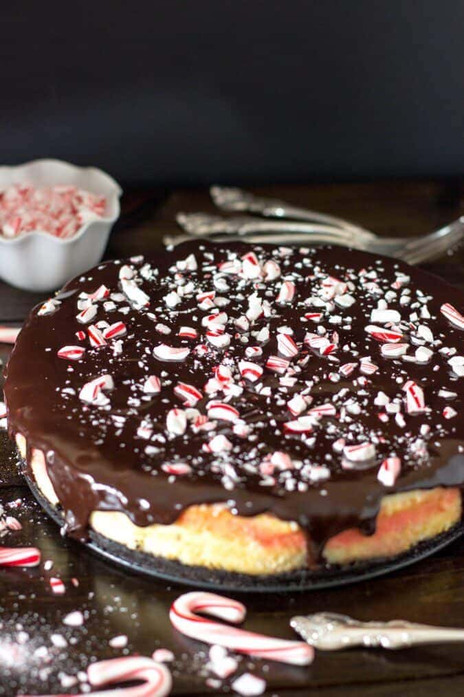 cheesecake covered with ganache and candy cane pieces