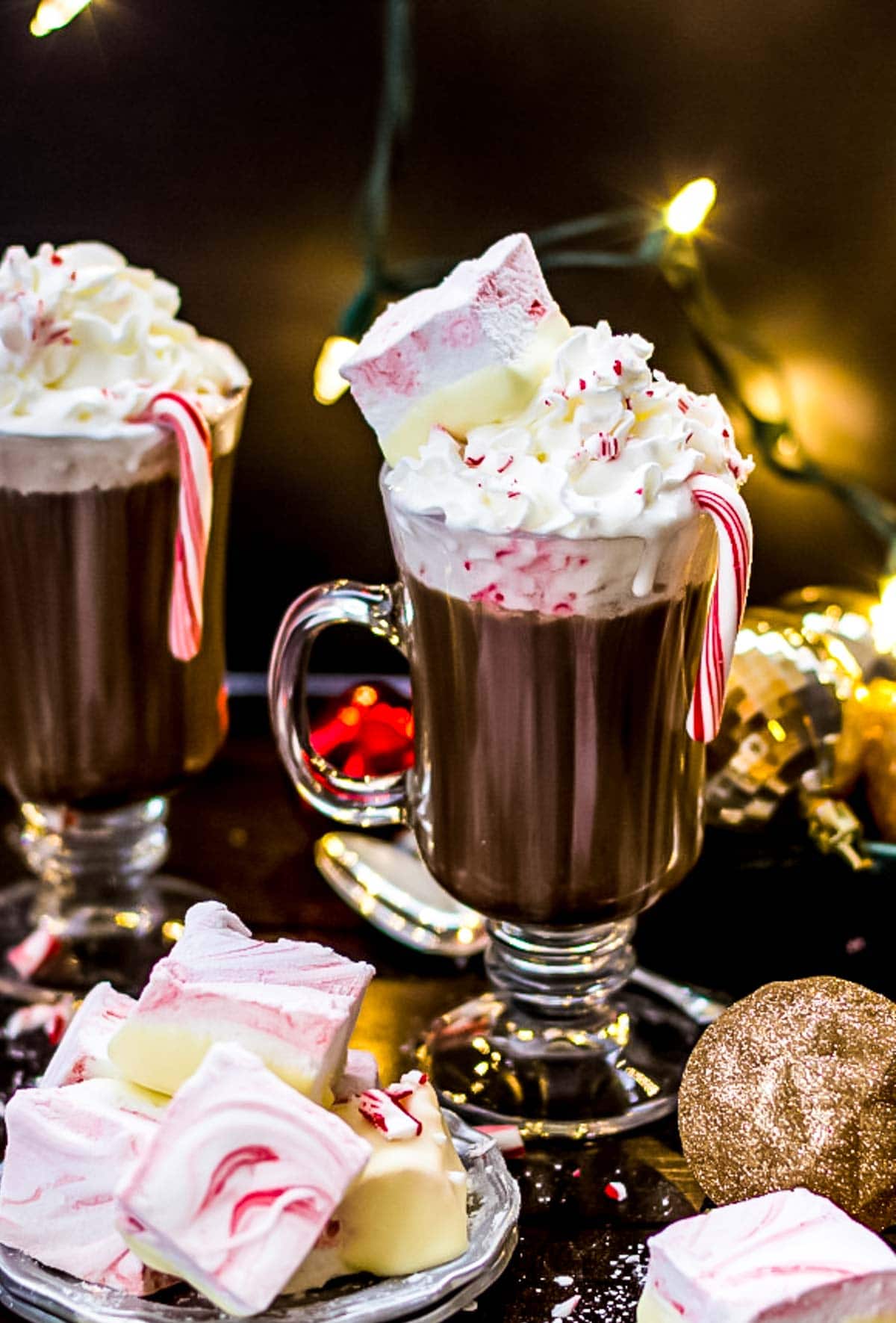 Cup of hot cocoa topped with whipped cream and peppermint marshmallows