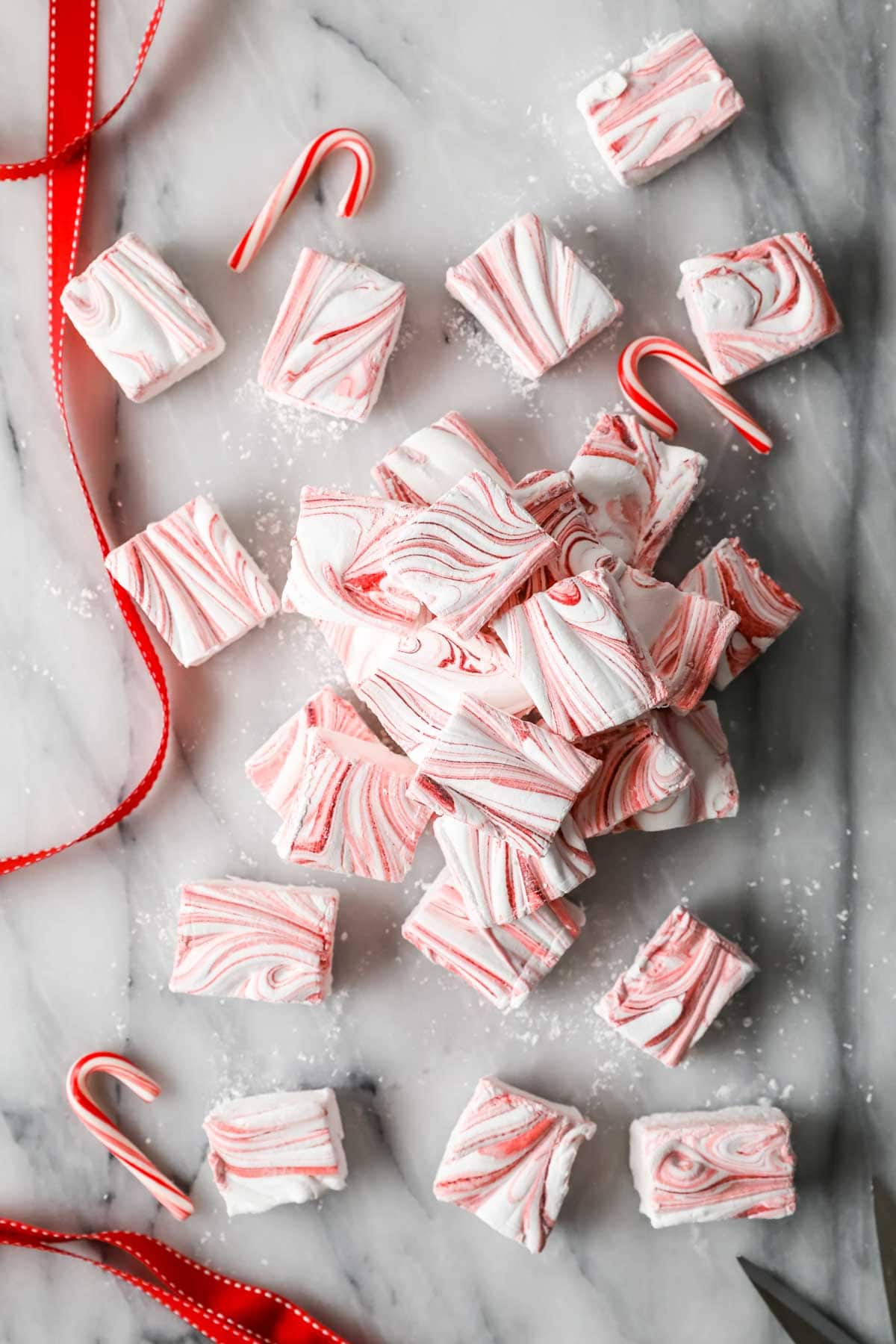 Overhead of red-swirled peppermint marshmallows cut into squares