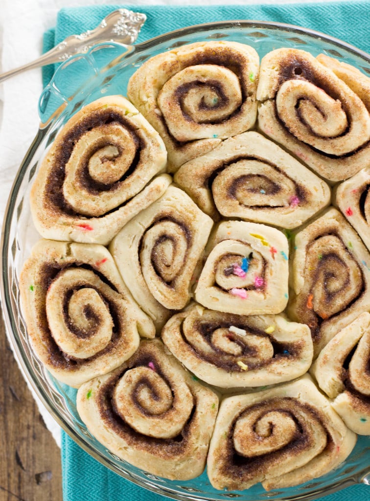 Overhead: sprinkled cinnamon rolls in pie plate