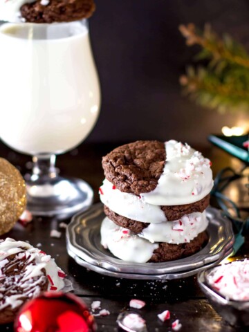 Stack of four peppermint bark cookies on a silver plate