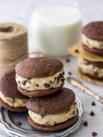 Stack of three cookie dough whoopee pies on a silver plate