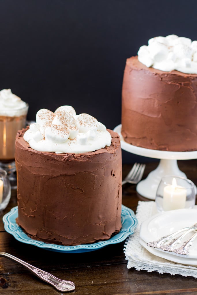 chocolate frosted cake topped with marshmallows on blue plate