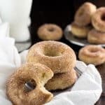 Snickerdoodle donuts stacked on a silver plate