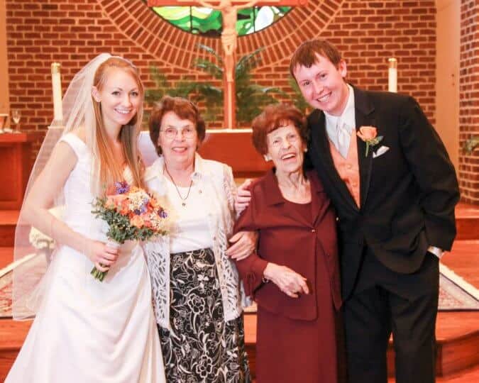 bride and groom at alter with grandmother and huge-grandmother  Sizzling Chocolate Cake Mom Mom Russell 675x540