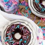 Overhead of baked chocolate donuts with chocolate glaze and sprinkles
