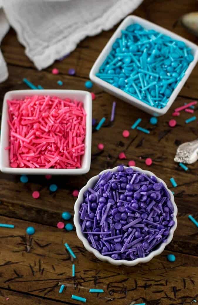 pink blue and purple homemade sprinkles in white dishes