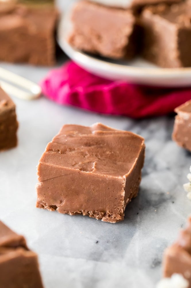 Creamy square of old-fashioned chocolate fudge on marble board.