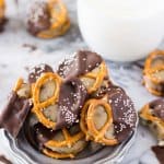 Chocolate covered pretzel bites stuffed with cookie dough, piled on to a silver plate