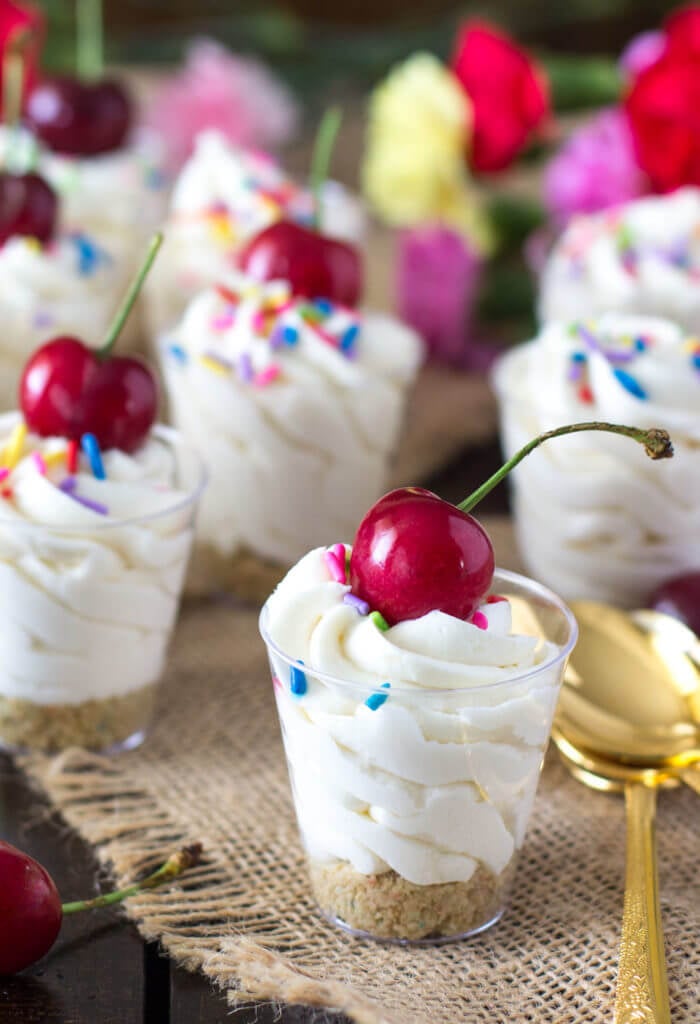 Cake batter dessert shooters topped with a cherry