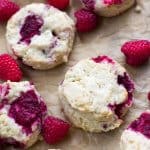 Raspberry scones laid out on parchment paper