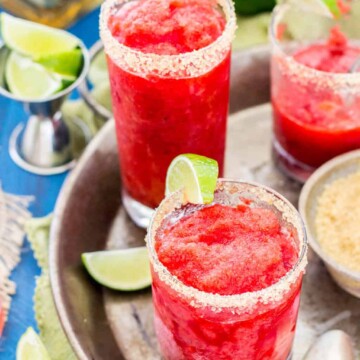 Strawberry margarita granita with a slice of lime, on a silver serving tray