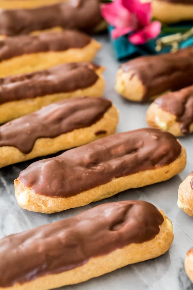 chocolate eclairs on a marble board