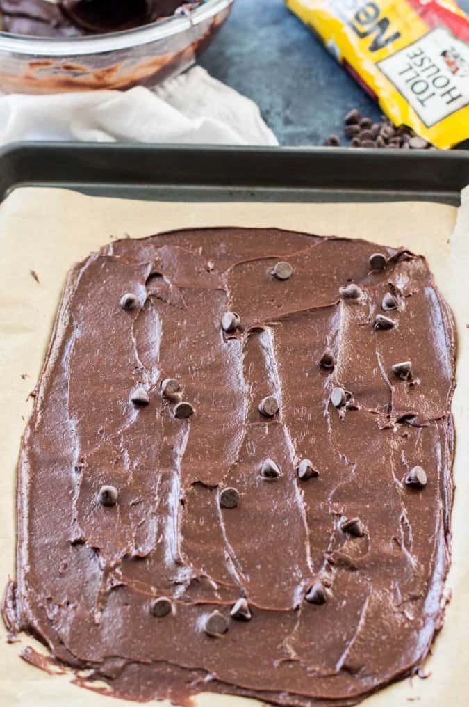 making brownie brittle: spread batter thin and top with chocolate chips