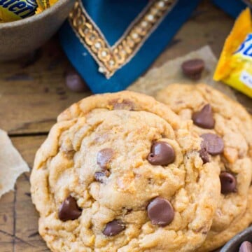 Butterfinger cookies with miniature butterfinger candy bars in the background