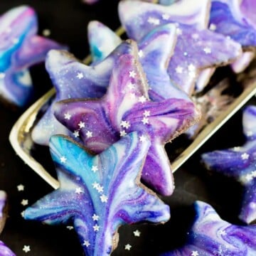 Star shaped galaxy cookies stacked on a silver tray