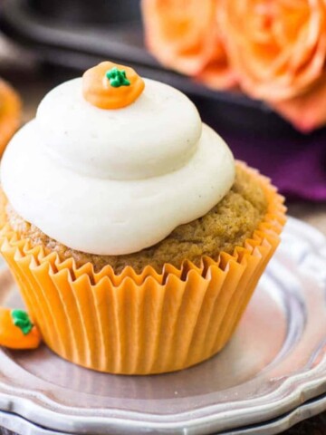 Pumpkin cupcake with frosting on silver plate