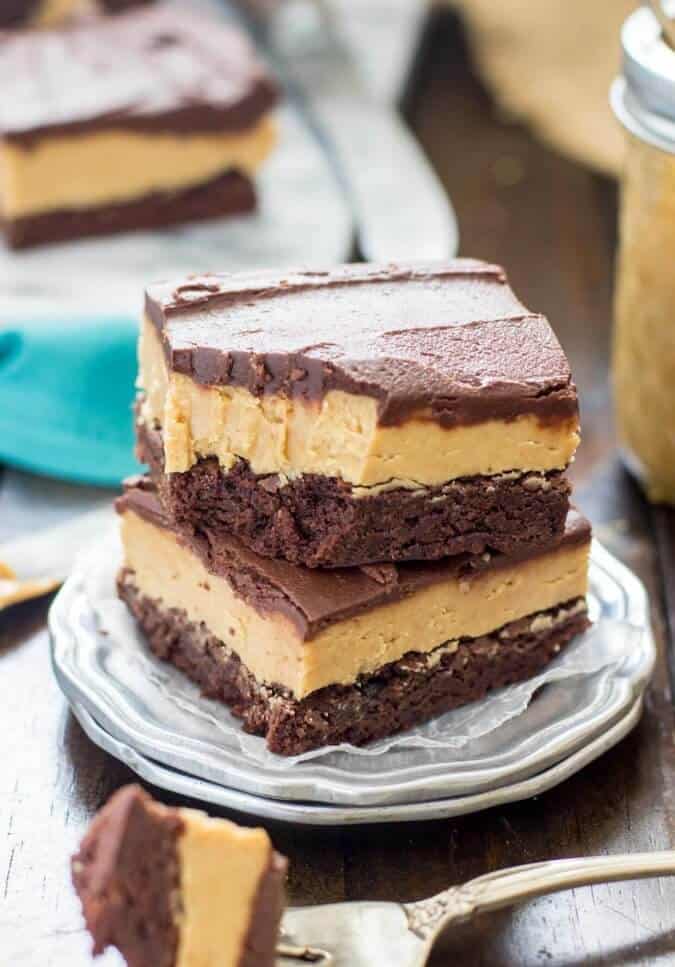 Two buckeye brownies stacked on a silver plate