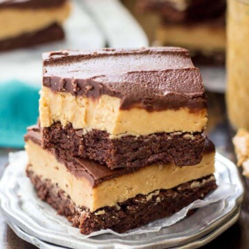 Two buckeye brownies stacked on a silver plate