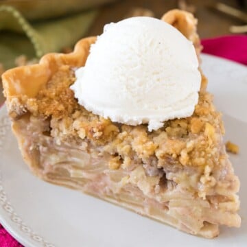 slice of apple pie with ice cream on white plate