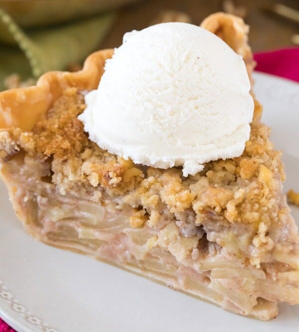 slice of apple pie with ice cream on white plate