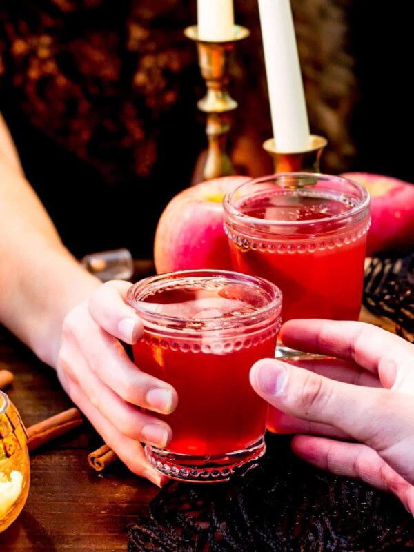 Glass of red liquid being handed off
