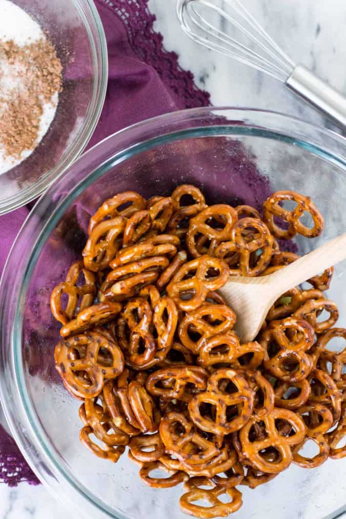Making candied pretzels: tossing pretzels in bowl with melted butter