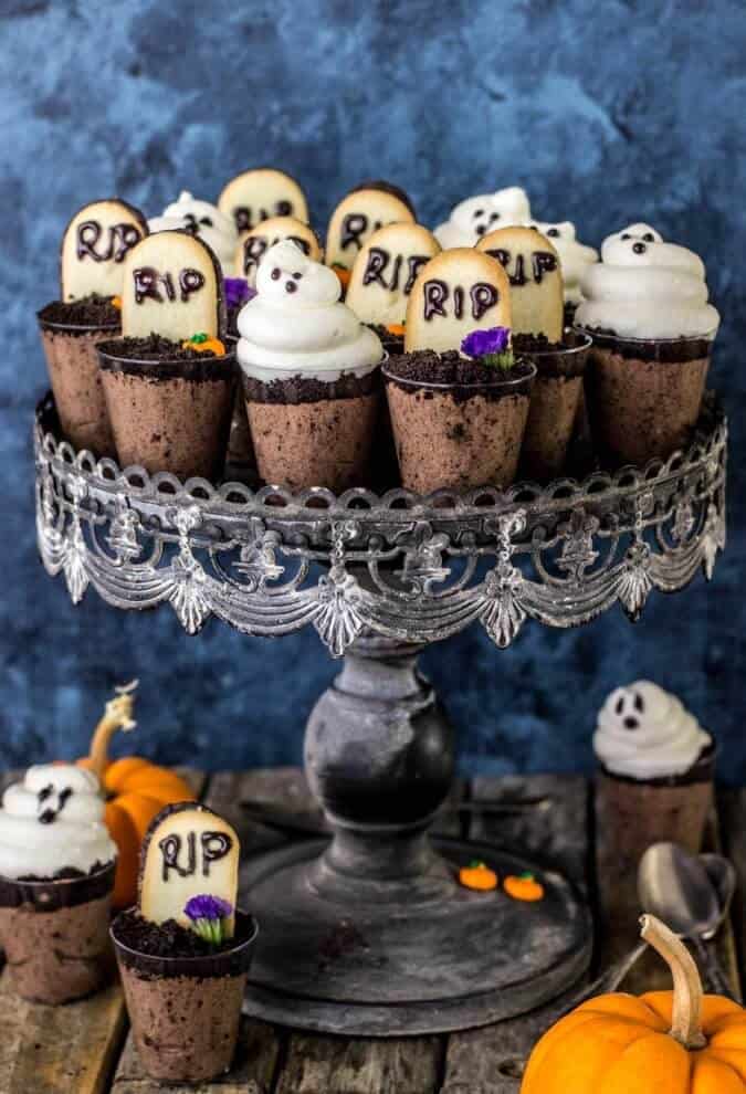 Ghost in the Graveyard Halloween Dessert Shooters displayed on a black cake stand