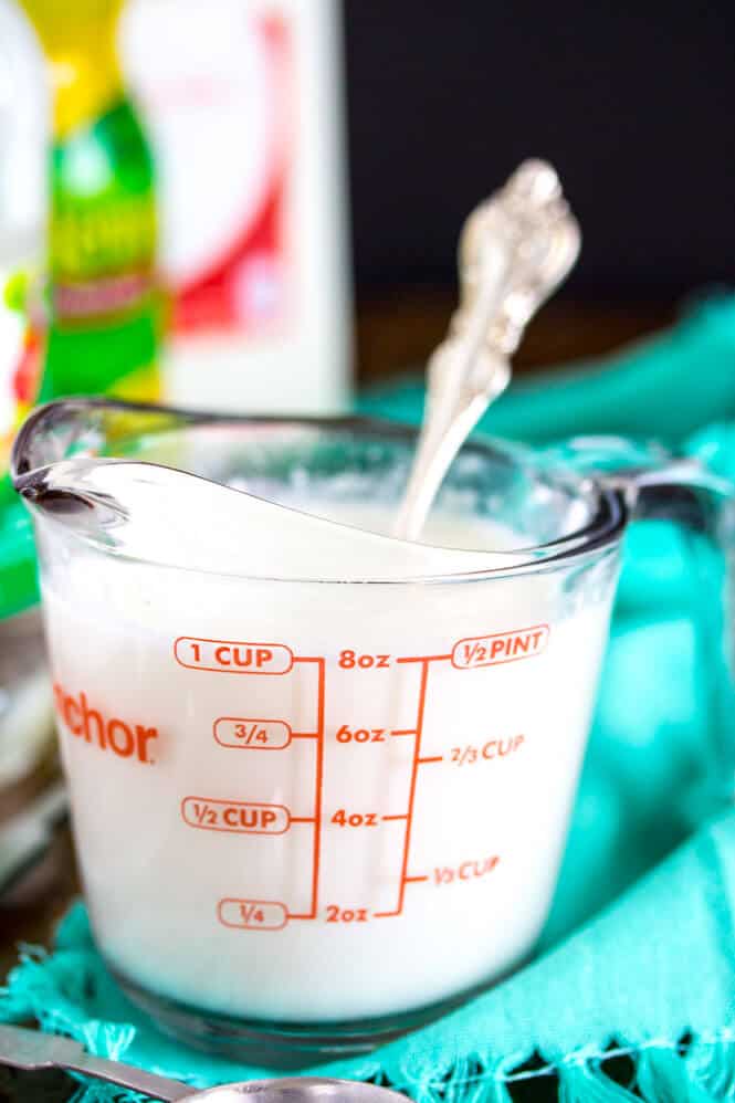 Stirring together milk and lemon juice in a measuring cup to make a buttermilk substitute