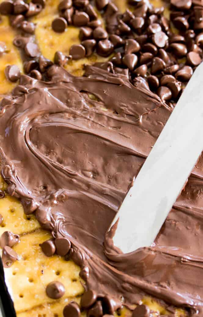 Metal spatula spreading melted chocolate chips