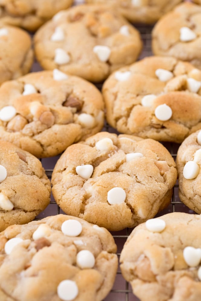 White chocolate chip macadamia nut cookies on a gold cooling rack