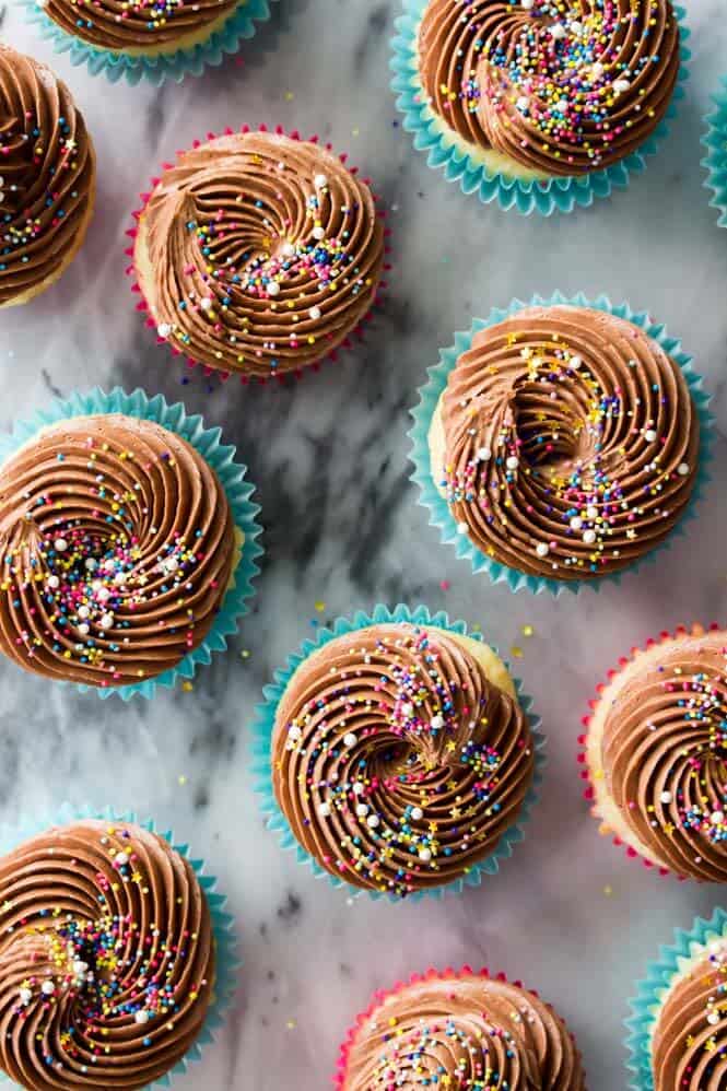 Vanilla cupcakes topped off with chocolate frosting and covered in sprinkles
