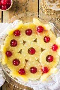 Overhead of pineapples and cherries in glass pie dish