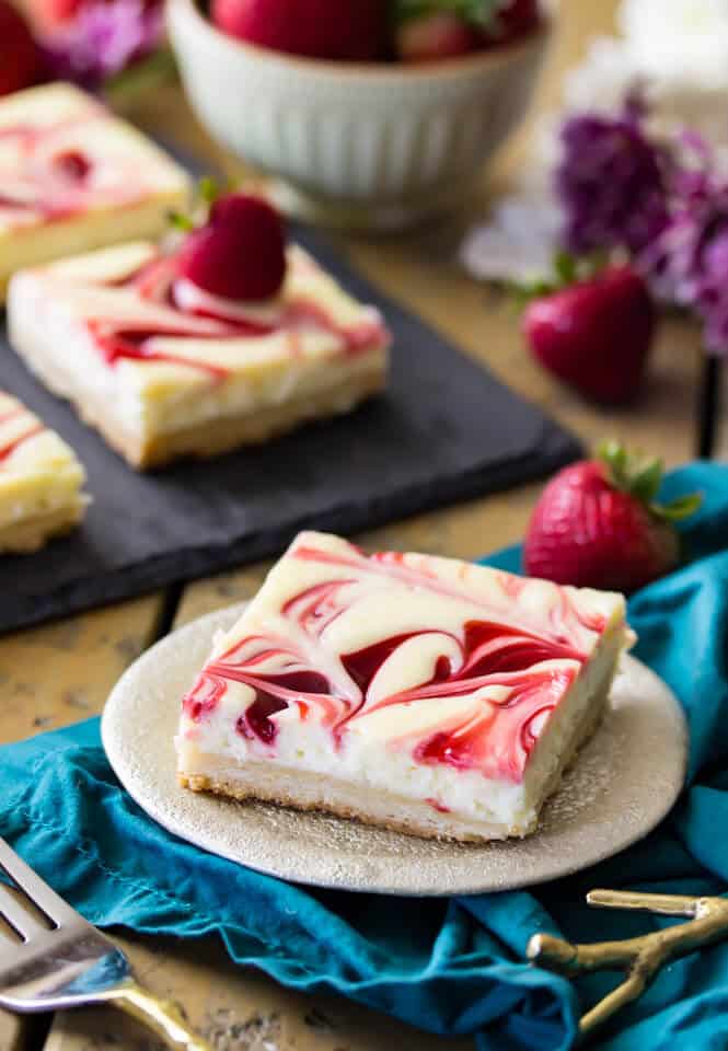 Berry Swirl Cheesecake Bars, a strawberry swirled lemon cheesecake on a shortbread crust