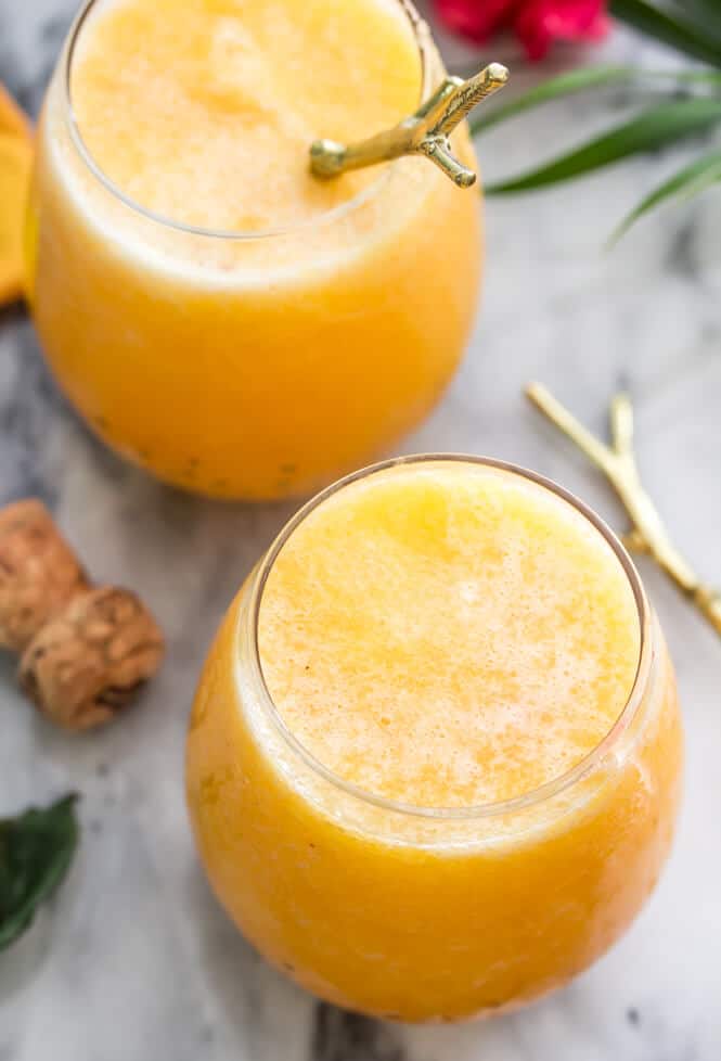 Overhead view of glasses with a frozen peach drink inside.